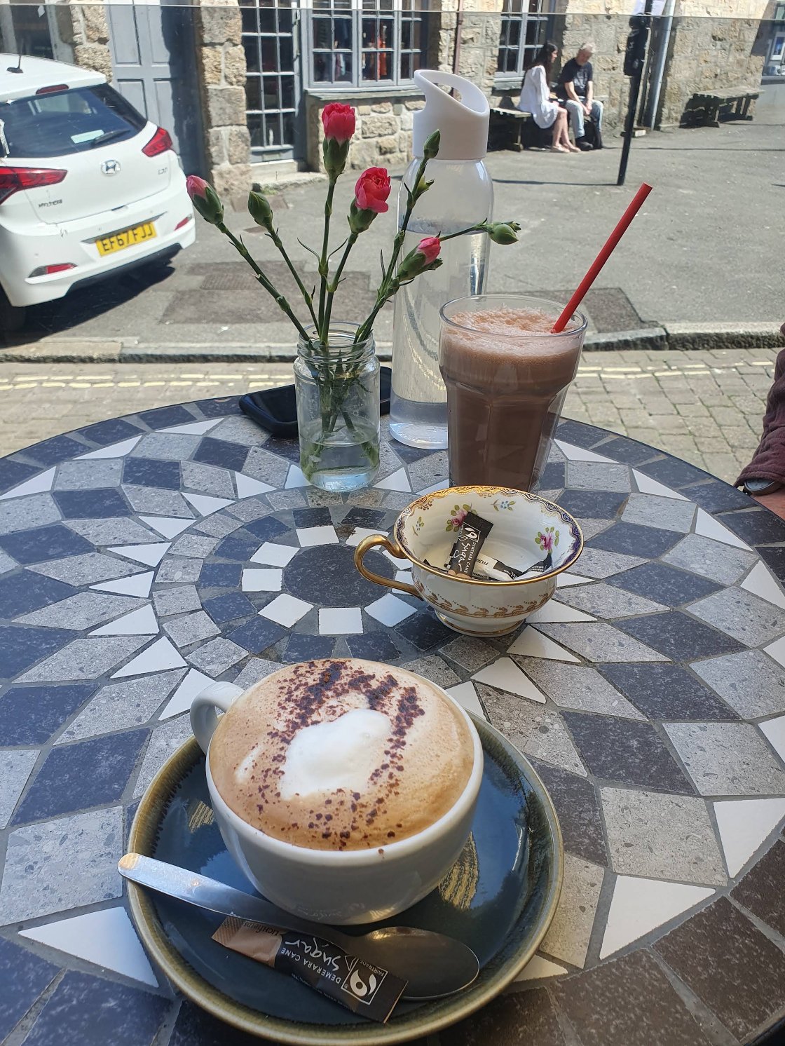 Coffee and cake at a table outside Cafe Art