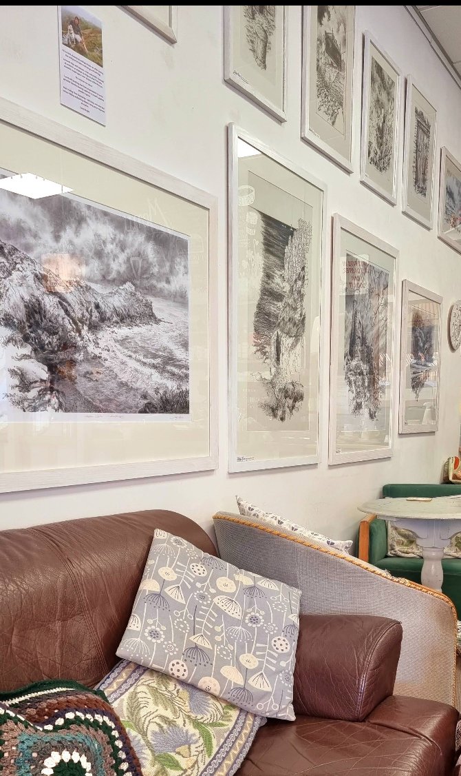 Framed artwork and a sofa inside Cafe Art